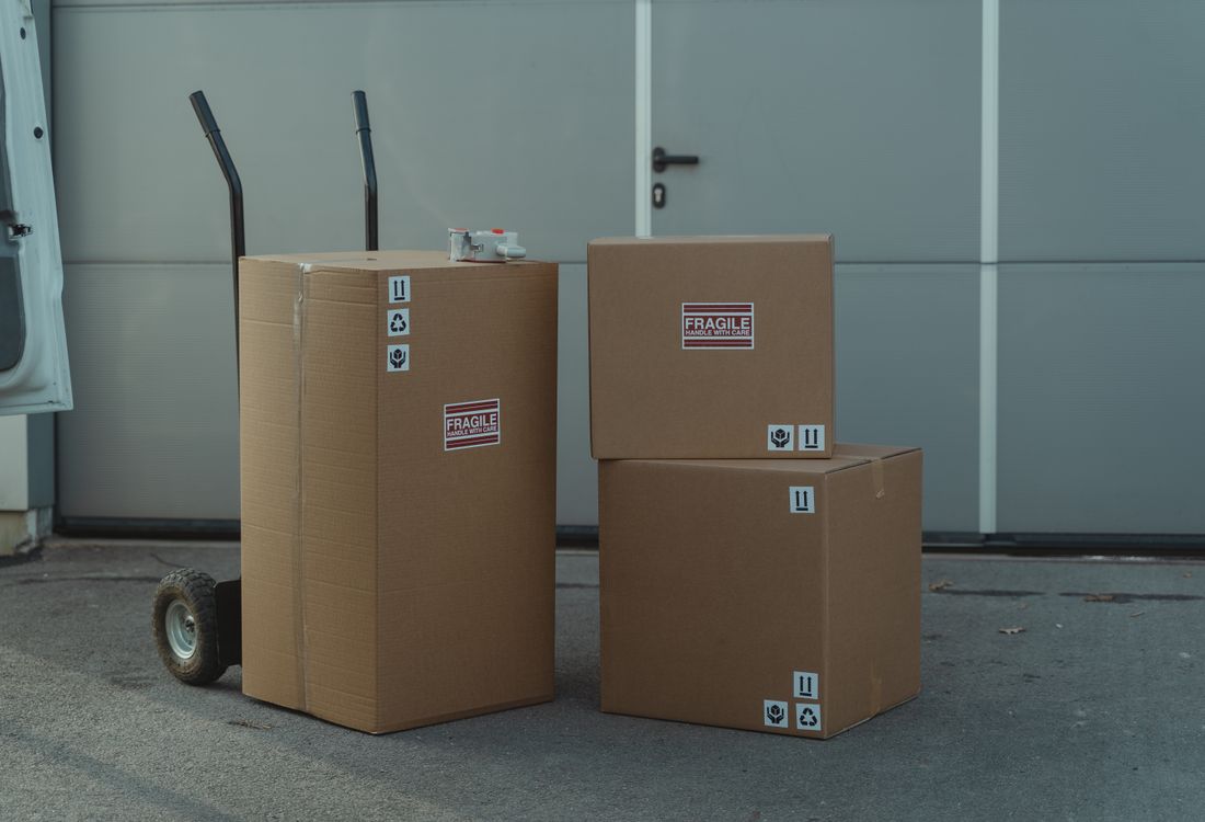 Finished corrugated master cartons stacked in rows across the factory floor awaiting dispatch