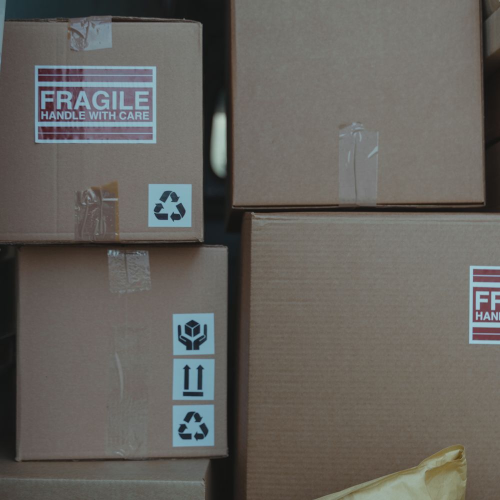 Stacked brown corrugated export cartons ready for shipment marking